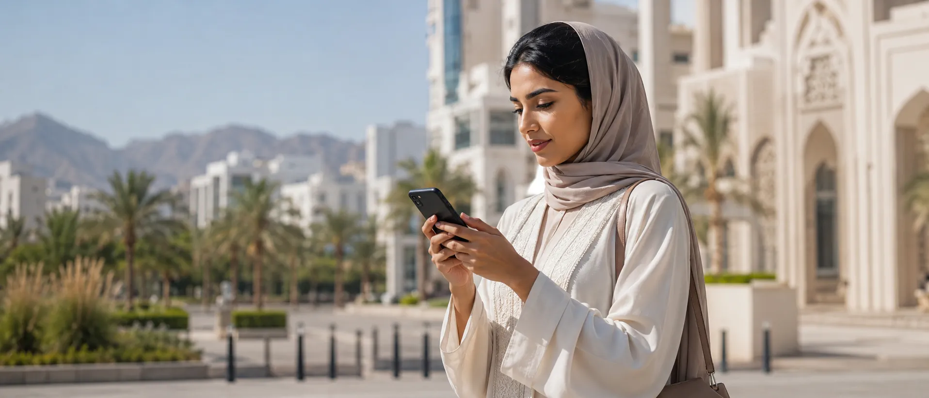 Omani woman using chatbot on her phone in Muscat